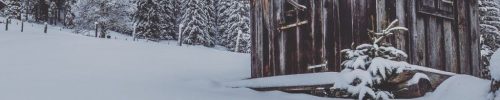 Small mountain ski hut on a snowy hillside